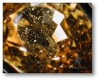 Zircon particle inclusions in Madagascan yellow sapphire.